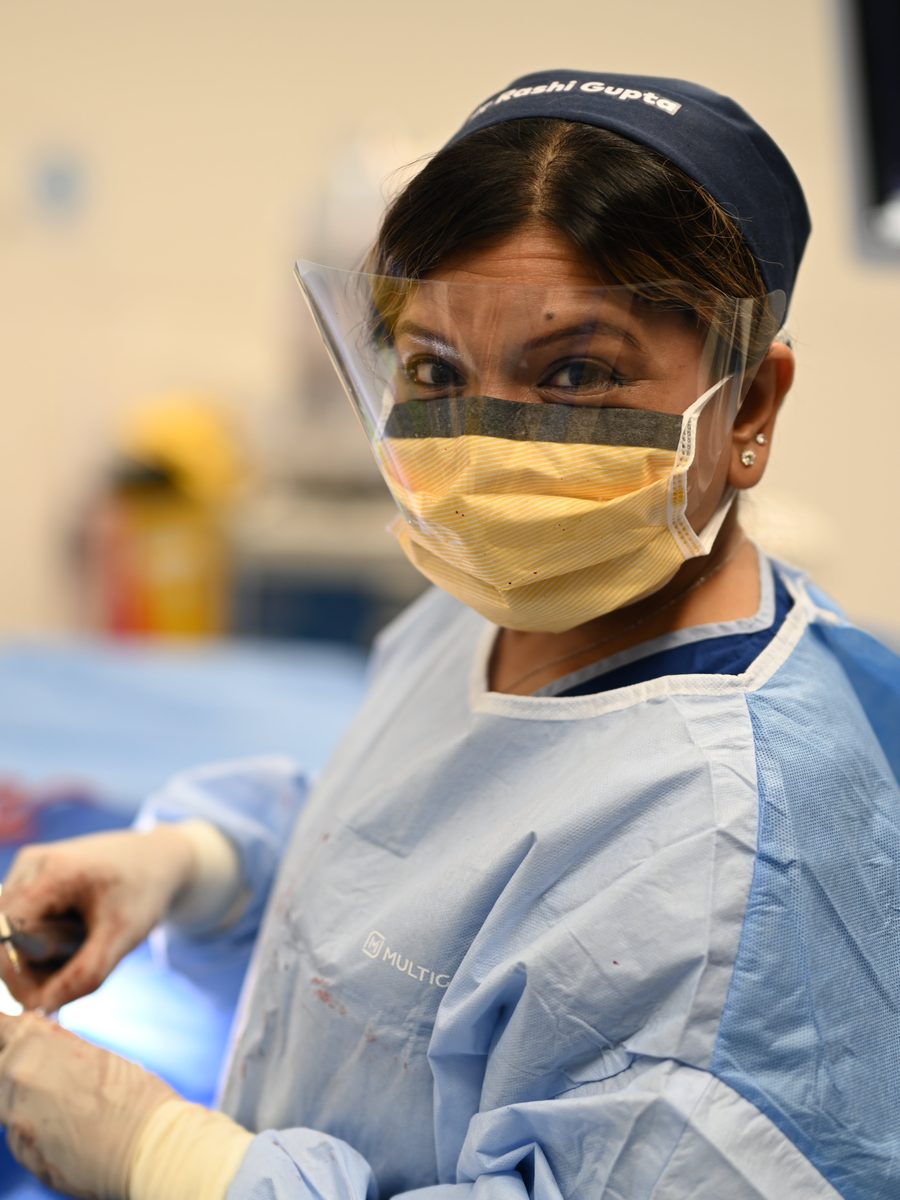 Dr Rashi Gupta performing implant surgery in theatre